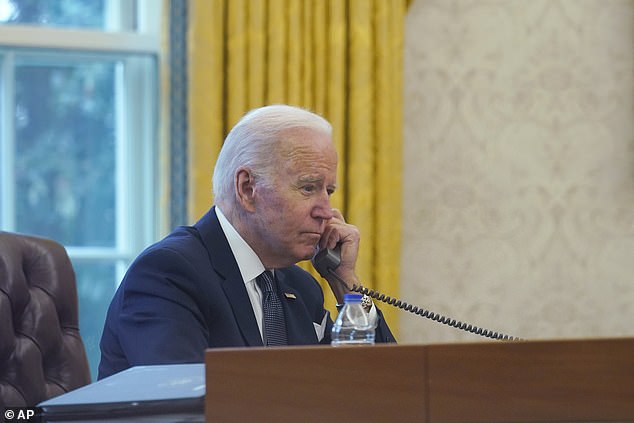 President Joe Biden talks on the phone