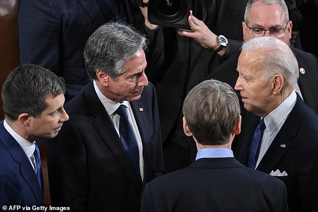 President Joe Biden (second from right) speaks with Secretary of Transportation Pete Buttigieg (left), Secretary of State Antony Blinken (second from left) and Senator Michael Bennet (right, back to camera) as he delivered his remarks on the Israeli Prime Minister Benjamin Netanyahu