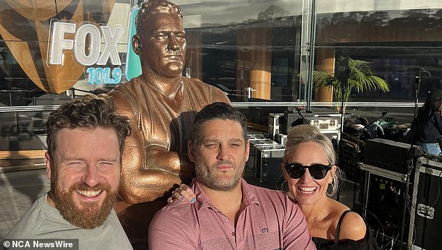 Fevola (centre, with his radio co-stars Fifi Box, right, and Nick Cody, left) is pictured with a statue unveiled in his honor in Narre Warren, the Melbourne suburb where he grew up