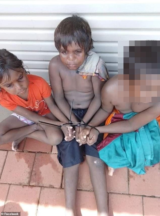 Margaret, six, and Stuart, seven, are pictured tied together with another family member on Tuesday