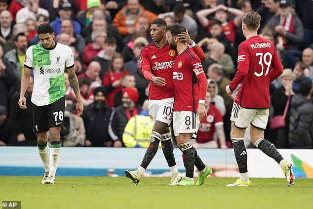 Man United captain Bruno Fernandes talks to Marcus Rashford after his miss on Sunday