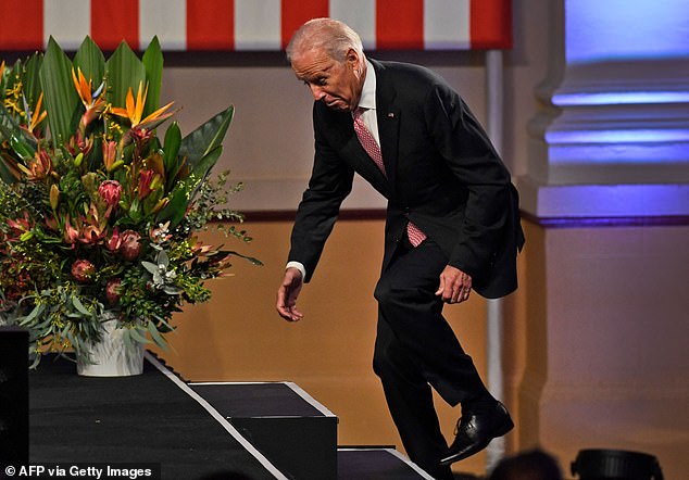 Then Vice President Joe Biden stumbles as he walks onto the stage to deliver a speech at Paddington Town Hall in Sydney on July 20, 2016.