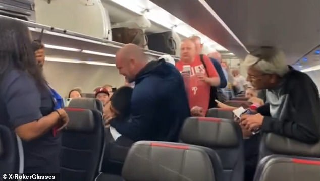 An unruly American Airlines passenger was put in a chokehold by another passenger before being escorted off a plane.  (photo: the disruptive kite in a stranglehold)