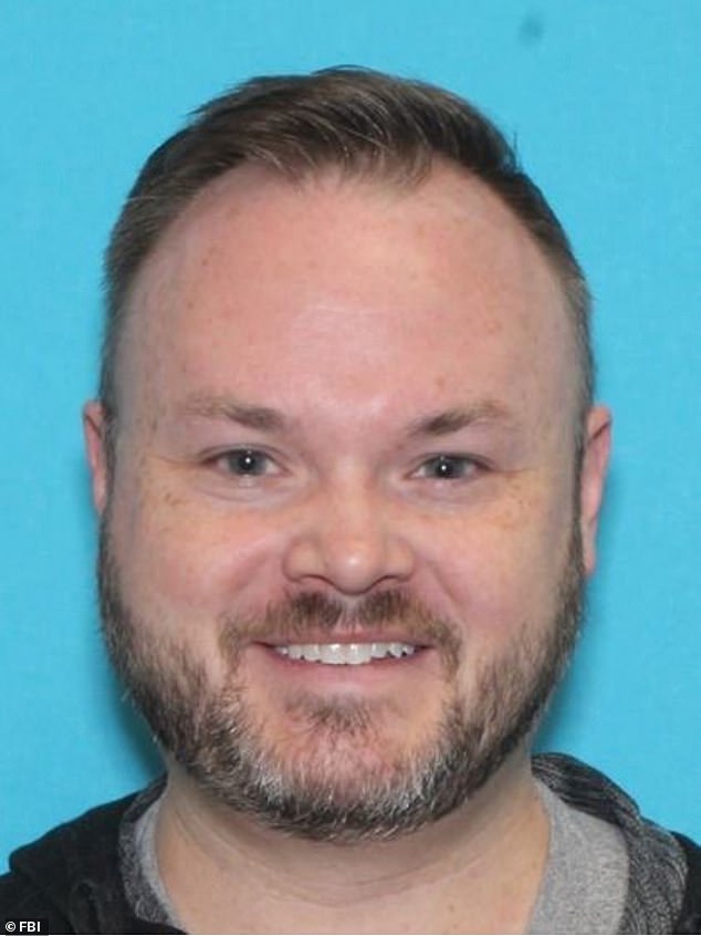 Adam Stafford King, pictured in a driver's license photo, has been charged with knowingly distributing child pornography following an investigation led by the FBI.