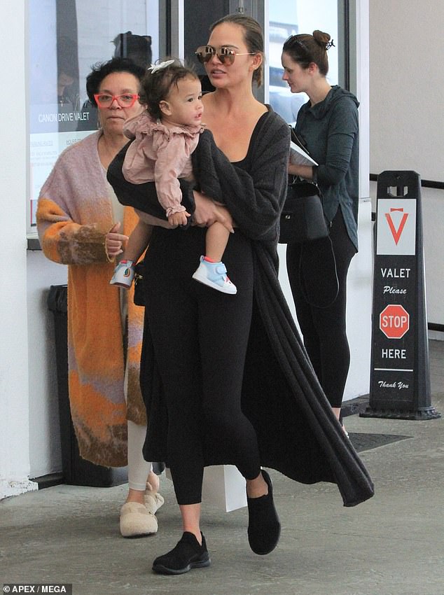 Chrissy Teigen enjoyed some time off in Los Angeles on Thursday after a recent work vacation.  The model, 38, looked relaxed as she held her daughter Esti, 14 months, after a spa visit in Los Angeles