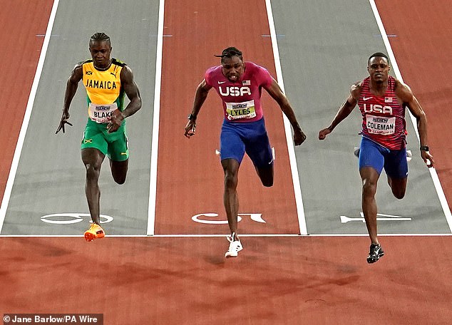 Christian Coleman (right) defeated Noah Lyles (center) to claim gold in the men's 60m final at the World Indoor Athletics Championships on Friday