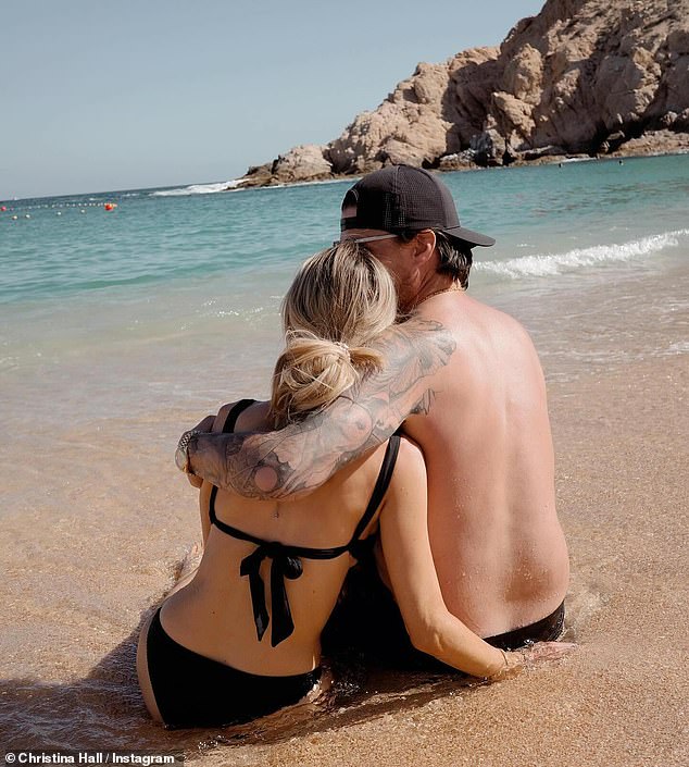 Christina Hall and her husband Joshua Hall shared some swimsuit photos on Tuesday.  The 40-year-old blonde beauty and her 43-year-old husband held and kissed on the beach of Cabo San Lucas, Mexico