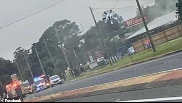 Firefighters and police remain on the scene (pictured) of a massive fire that destroyed a bakery and an adjacent house