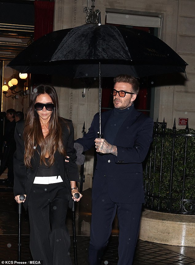 The former footballer helped the ex Spice Girl as they headed to a family dinner just 24 hours after her successful fashion week show in the city