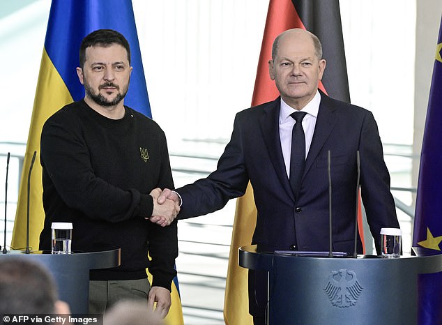 Ukrainian President Volodymyr Zelensky and German Chancellor Olaf Scholz shake hands after signing a security deal last month
