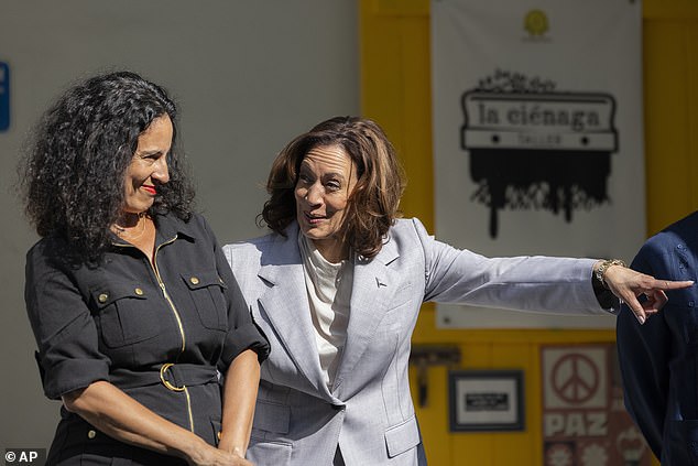 Vice President Kamala Harris clapped, smiled and waved to the music played Friday outside her tour of a cultural center in Puerto Rico, but stopped abruptly when it appeared Executive Director Mariana Reyes (left) informed her of the translation of the texts