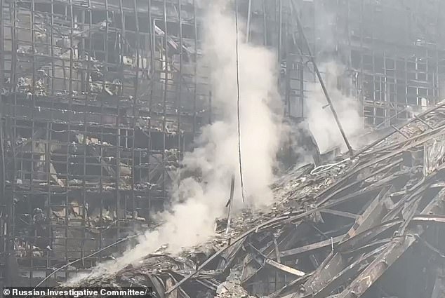 A day after the horrific attack, the smoldering remains of the concert hall can be seen here