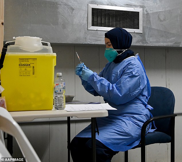 A Queensland court has ruled that mandatory Covid vaccines for police in that state were illegal (Photo: A nurse preparing a vaccine dose in Sydney in 2021)