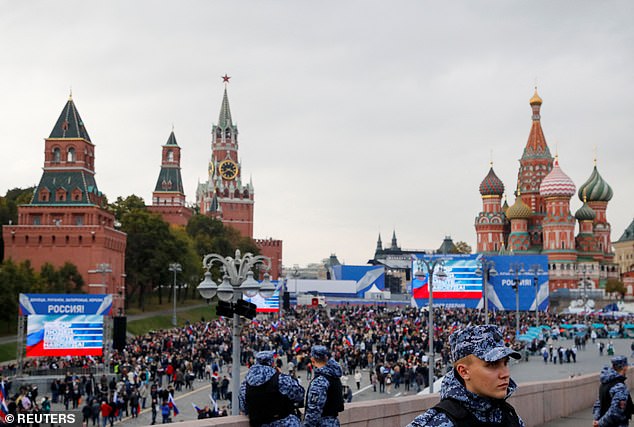 Law enforcement officers stand guard as people walk to Red Square to attend events marking the annexation of Russia-controlled areas of Ukraine, September 30, 2022