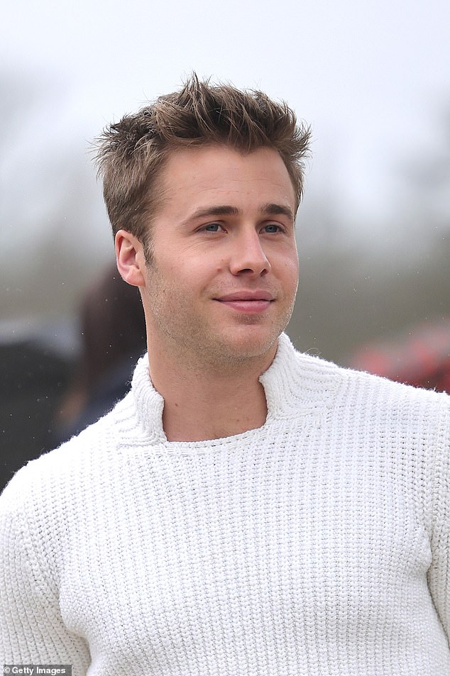 The 24-year-old actor - who plays Prince William in season six of The Crown - looked dapper as he wore a white knitted jumper with a quirky square neckline