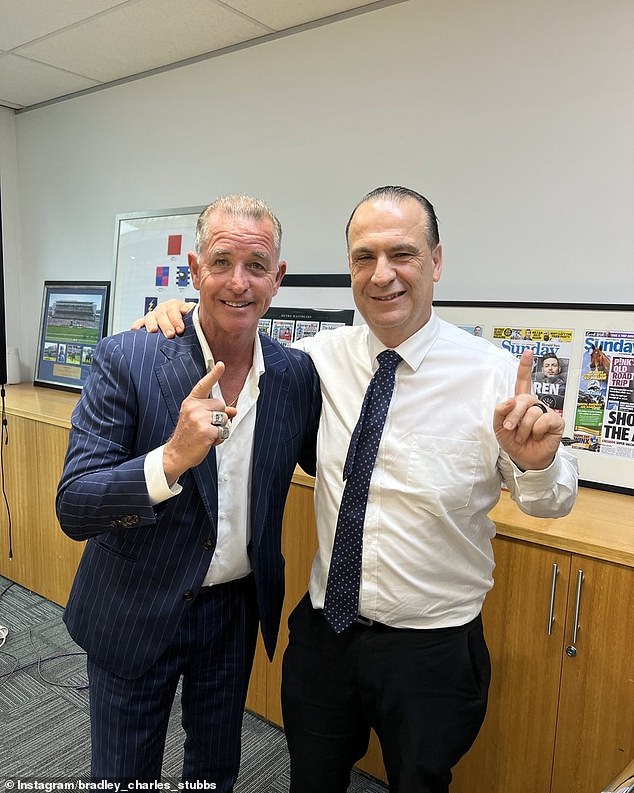 Bradley Charles Stubbs (pictured left with NRL boss Peter V'landys) wears premiership rings (on his right hand, above) after helping Trent Robinson take the Roosters to victory