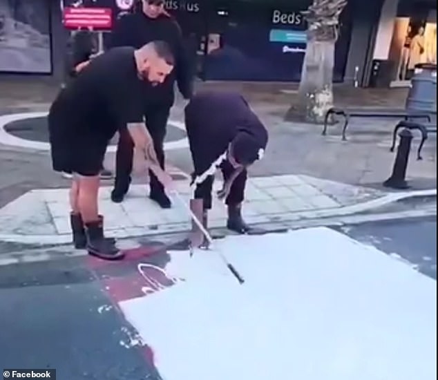 Members of the evangelical Destiny Church paint an LGBTQIA+ crossing in the New Zealand city of Gisborne to protest a local library hosting a drag storytelling event for teens