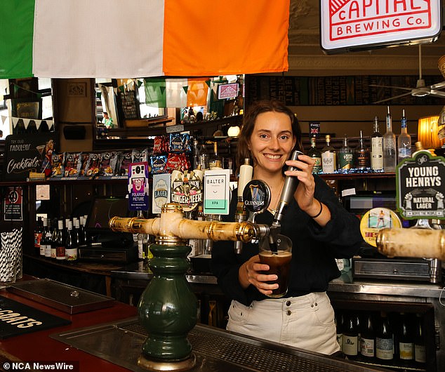 Emma Olrik, a bartender at the Australian Hotel in the Rocks, serves a Guinness on Saturday ahead of the official St Patricks Day on Sunday, March 17