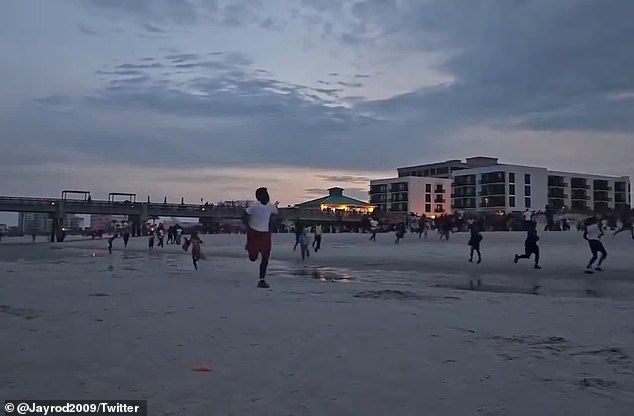 People could be seen running onto the beach in Jacksonville on Sunday evening to escape the gunfire