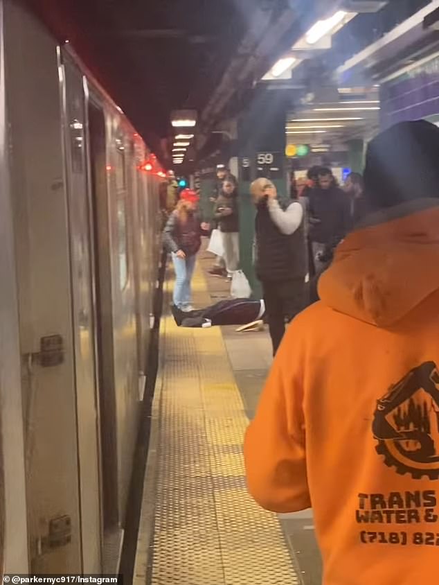 Wild footage captured the moment a determined subway rider dragged the unconscious body of a passenger from a train surrounded by commuters