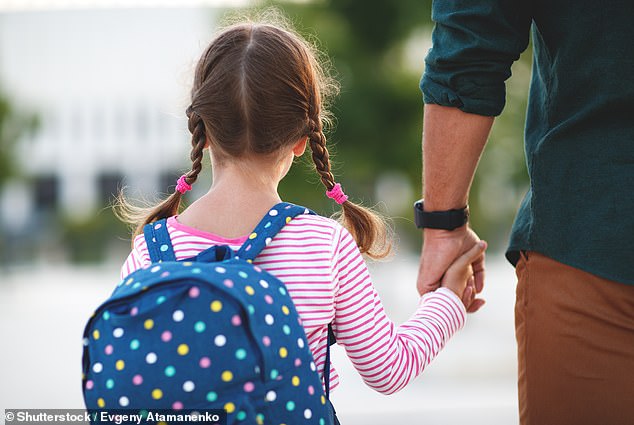 Lucy shares responsibility for school management with her husband, but admits that she largely carries it out herself.  Above is a father walking his daughter to school (stock image)