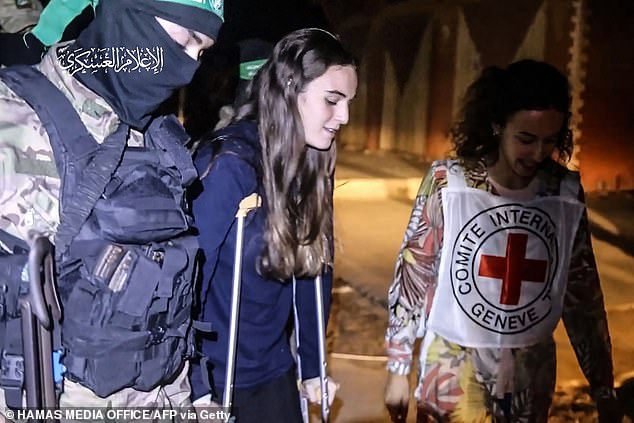 An image from a handout video released by the Hamas Media Office shows a Hamas fighter and a Red Cross medic who accompanied Maya when she was released in November