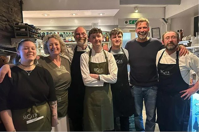 Jurgen Klopp (second right) posed with restaurant staff after a visit to a Cornish seaside town