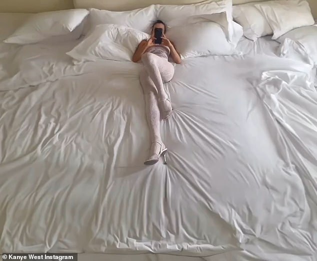 On Friday, the Vultures artist posted a photo of Censori, 29, wearing a strapless white lace leotard and white high-heeled sandals, lying in a white bed.  'I think it's you who says: "My bitch lives in luxury,” said Malik Yusef, a musical partner of West, about the photo