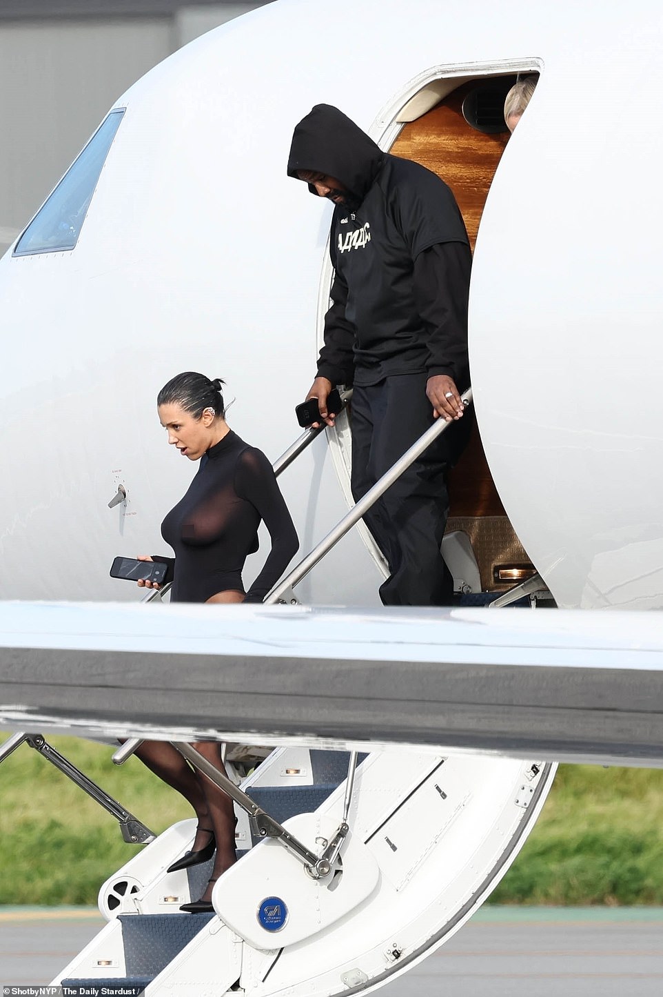 Kanye West's Australian wife Bianca Censori put on another scandalous performance on Wednesday as she left a private jet with her husband in Los Angeles