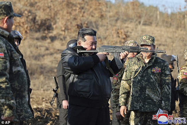 North Korean leader Kim Jong Un brandished a gun as he inspected a major operational training base and urged his military to step up 