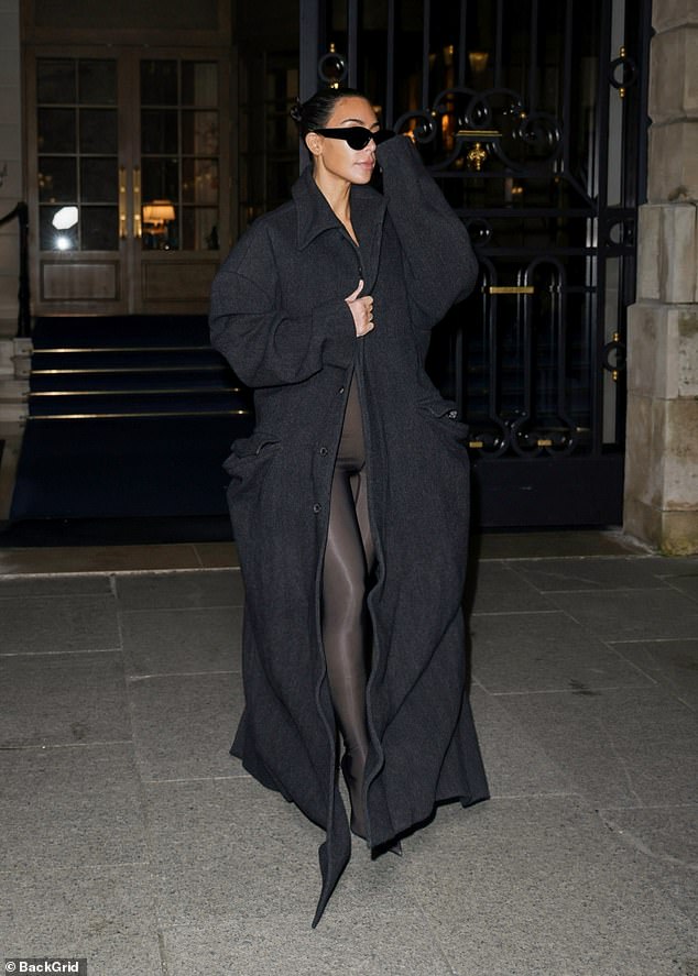 Kim Kardashian revealed a glimpse of her sheer bodysuit as she stepped out of the Ritz hotel in Paris during fashion week on Monday night