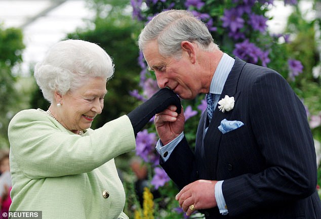 Charles kisses the hand of his mother, Queen Elizabeth, after she presented him with the Royal Horticultural Society Victoria Medal of Honor in May 2009