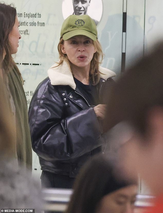 Kylie Minogue showed off her ageless face on Tuesday as she touched down at Sydney Airport during a break from her permanent residency in Las Vegas