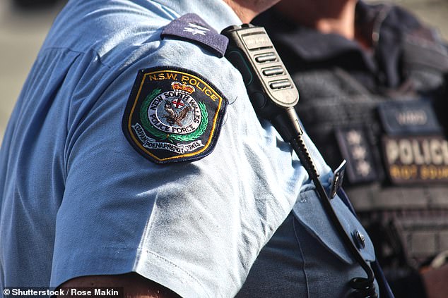 A 21-year-old man has been charged with murder after allegedly stabbing another man at a house in Lake Macquarie, New South Wales, on Friday.  A NSW police officer is pictured