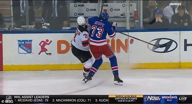 Rangers center Matt Rempe with a chicken wing on the Devils defenseman in the second period