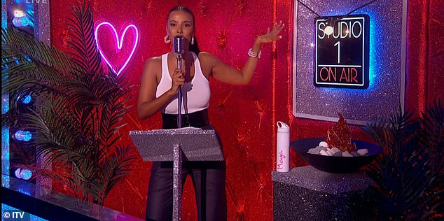 The Love Island presenter paired her sleek white cardigan with sleek high-waisted black trousers and a thick black belt