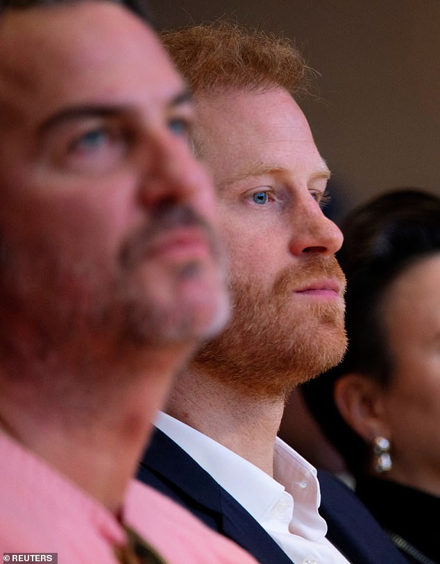 Prince Harry sat in the front row to support his wife Meghan, sitting next to her longtime friend and confidant Markus Anderson (left)