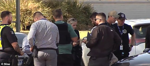 A 17-year-old boy has turned himself in to police after allegedly stabbing a 16-year-old male student at a Melbourne high school on Tuesday (photo, police on scene)