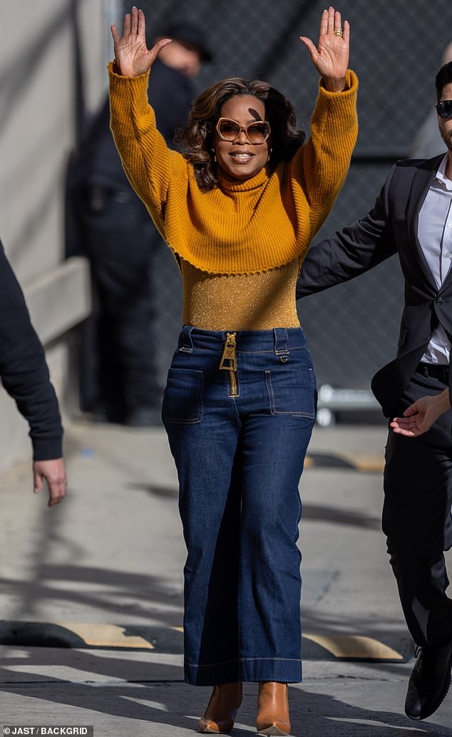 Oprah Winfrey showed off her dramatically slimmed waist in a figure-hugging orange outfit while in Hollywood this week