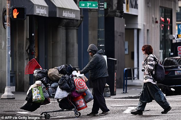 A bill that would recriminalize possession of small amounts of drugs passed the Oregon Legislature on Friday (Photo: A person pushes a cart along Southwest 3rd Avenue in Portland)