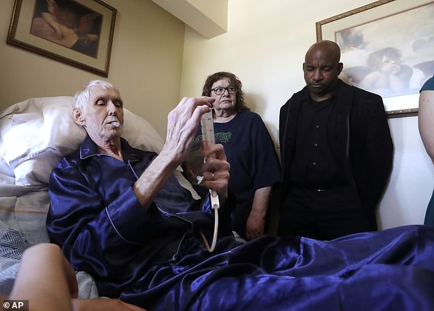 Physician-assisted suicide programs are available in all three West Coast states.  Pictured: Robert Fuller begins putting the drugs that will end his life into his feeding tube in Seattle, Washington