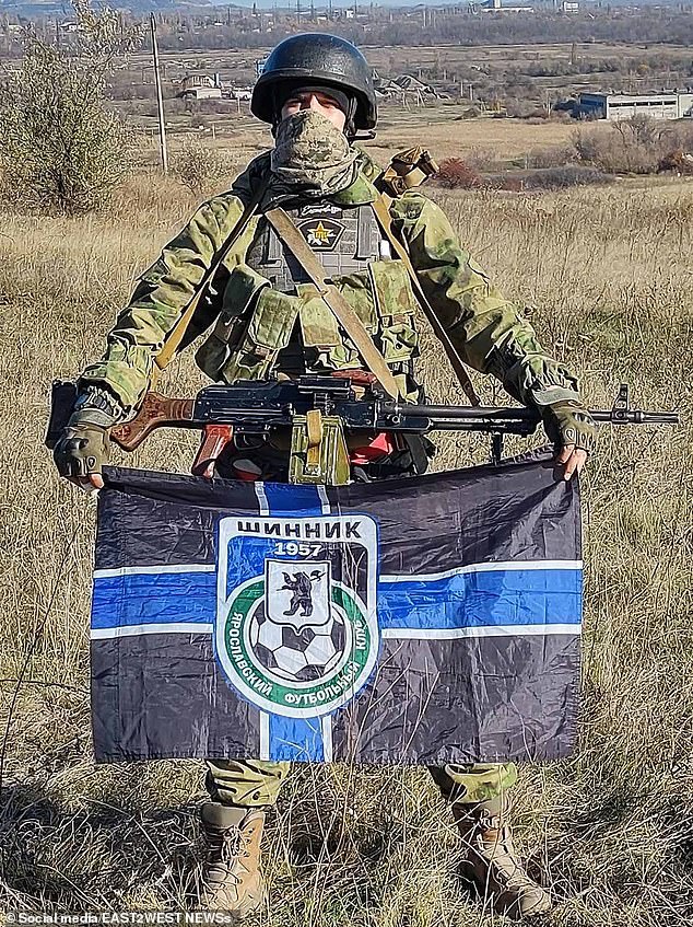 Española Battalion CSKA supporter Stanislav 'Spaniard' Orlov pictured with a Shinnik Yaroslavl FC flag and an RPK light machine gun, reportedly in occupied Donetsk Oblast