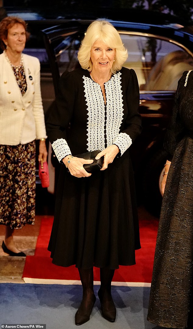 Queen Camilla opted for a black evening dress as she arrived at Marlborough House in Pall Mall in central London last night for a Commonwealth Day reception