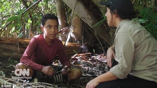 A hard-hitting documentary has shed light on the dangerous child labor involved in harvesting acai berries.  Pictured is journalist Julia Vargas Jones with 13-year-old acai picker Lucas Oliviera