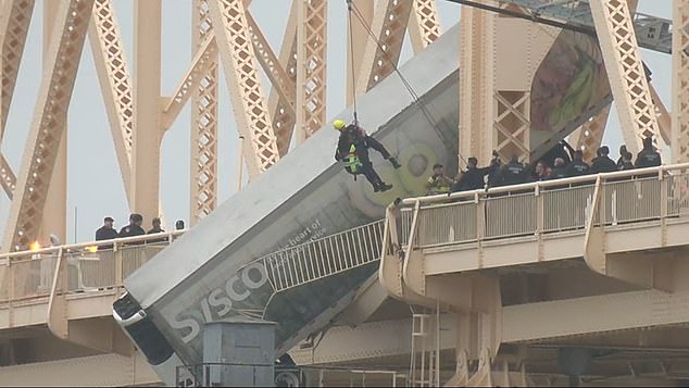 First responders were seen rappelling from the side of the Clark Memorial Bridge with the driver hanging precariously above the water