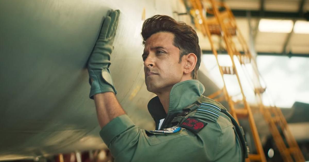 A pilot resting his hand on the outer fuselage of a fighter jet in Fighter.