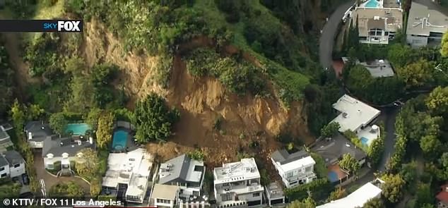 Three homes in Hollywood Hills, California were damaged by a landslide (pictured) on Sunday after heavy rainfall caused significant ground movement