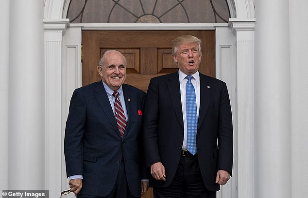 Former New York Mayor Rudy Giuliani (left) and President-elect Donald Trump (right) pose for a photo in Bedminster in November 2016, a few weeks after Trump won the 2016 race.  Giuliani became Trump's lawyer and four years later led efforts to overturn Biden's victory