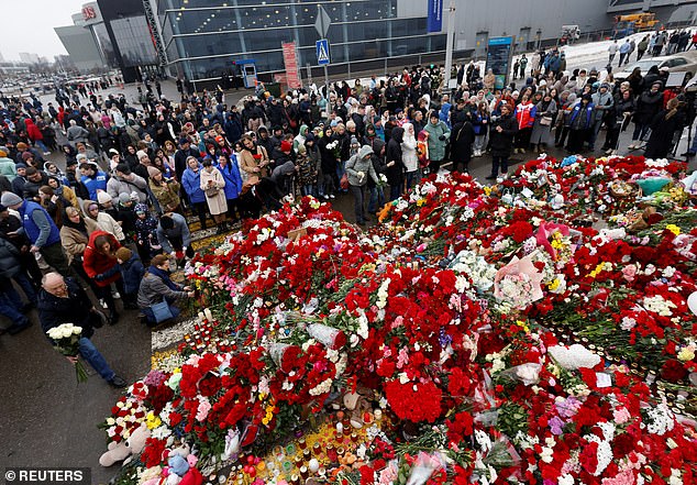 Hundreds of people gathered at the concert hall today to pay their respects and lay flowers as Russia declared a national day of mourning