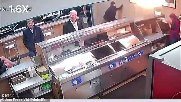 A man in a balaclava launched a fiery Molotov cocktail into a fish and chip shop as hungry elderly customers waited for their takeaway (pictured)